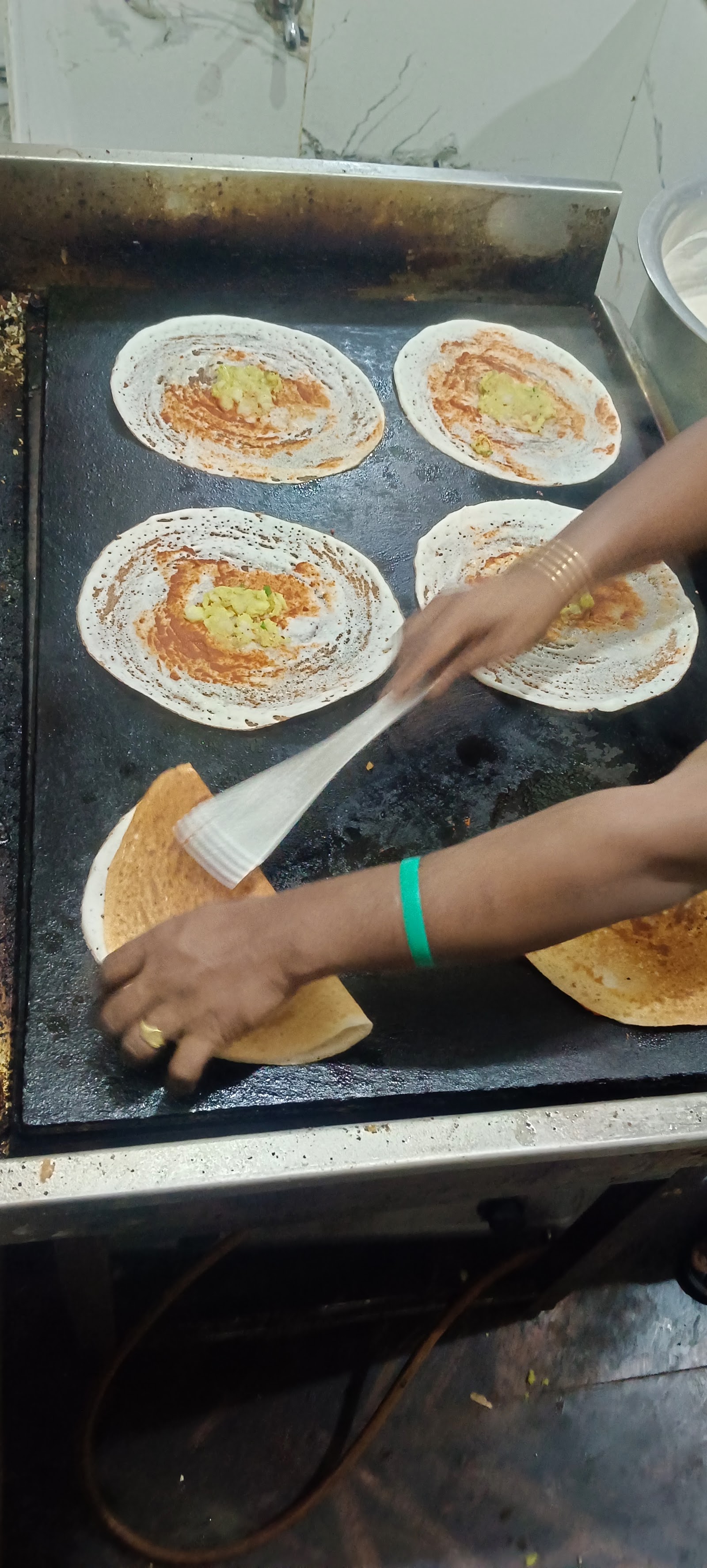 Fresh dosas being made in the At Home PG kitchen