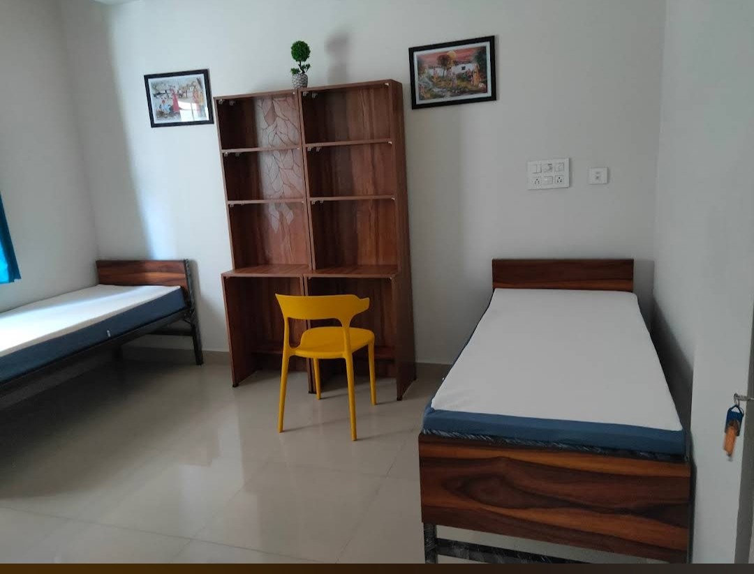 Room with study desk and bookshelf at At Home PG