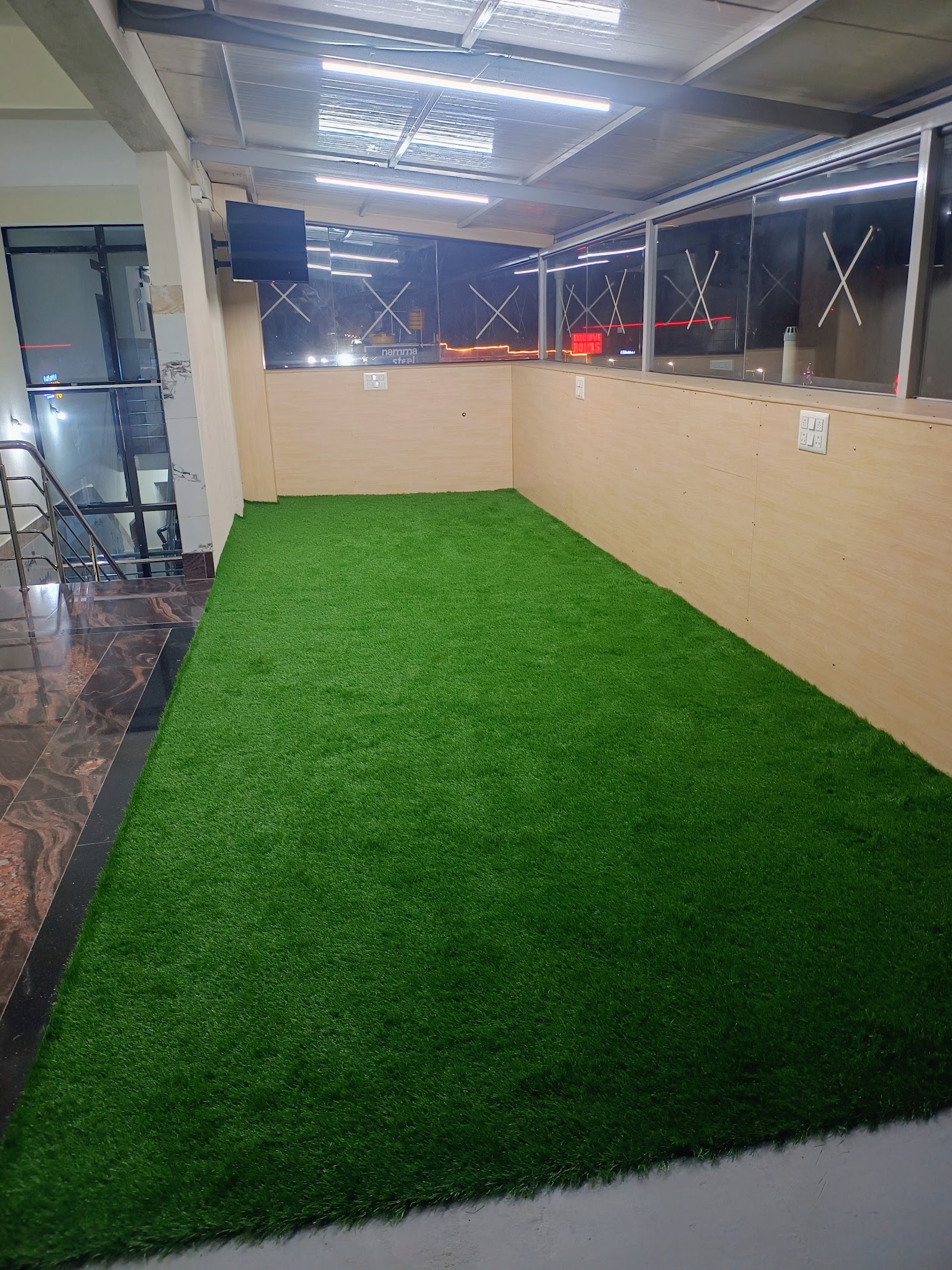 Terrace lounge with turf and TV at At Home PG